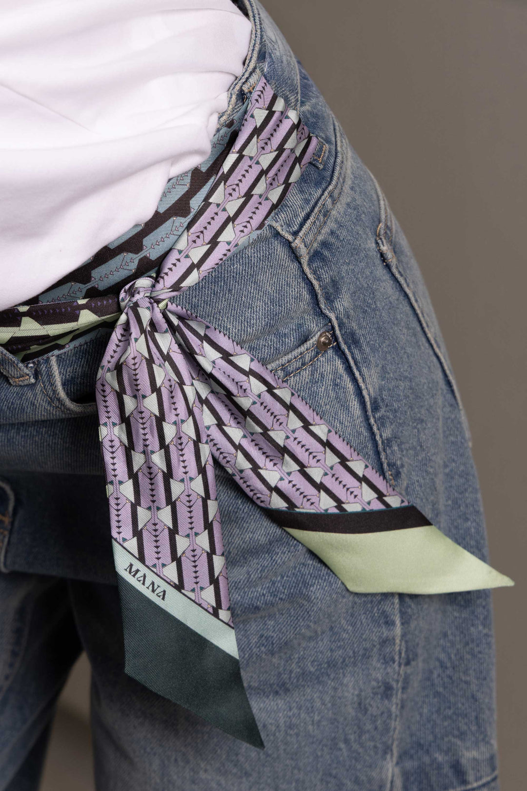 Double-sided luxury silk twill scarf worn as belt on jeans by MÀNA Amsterdam