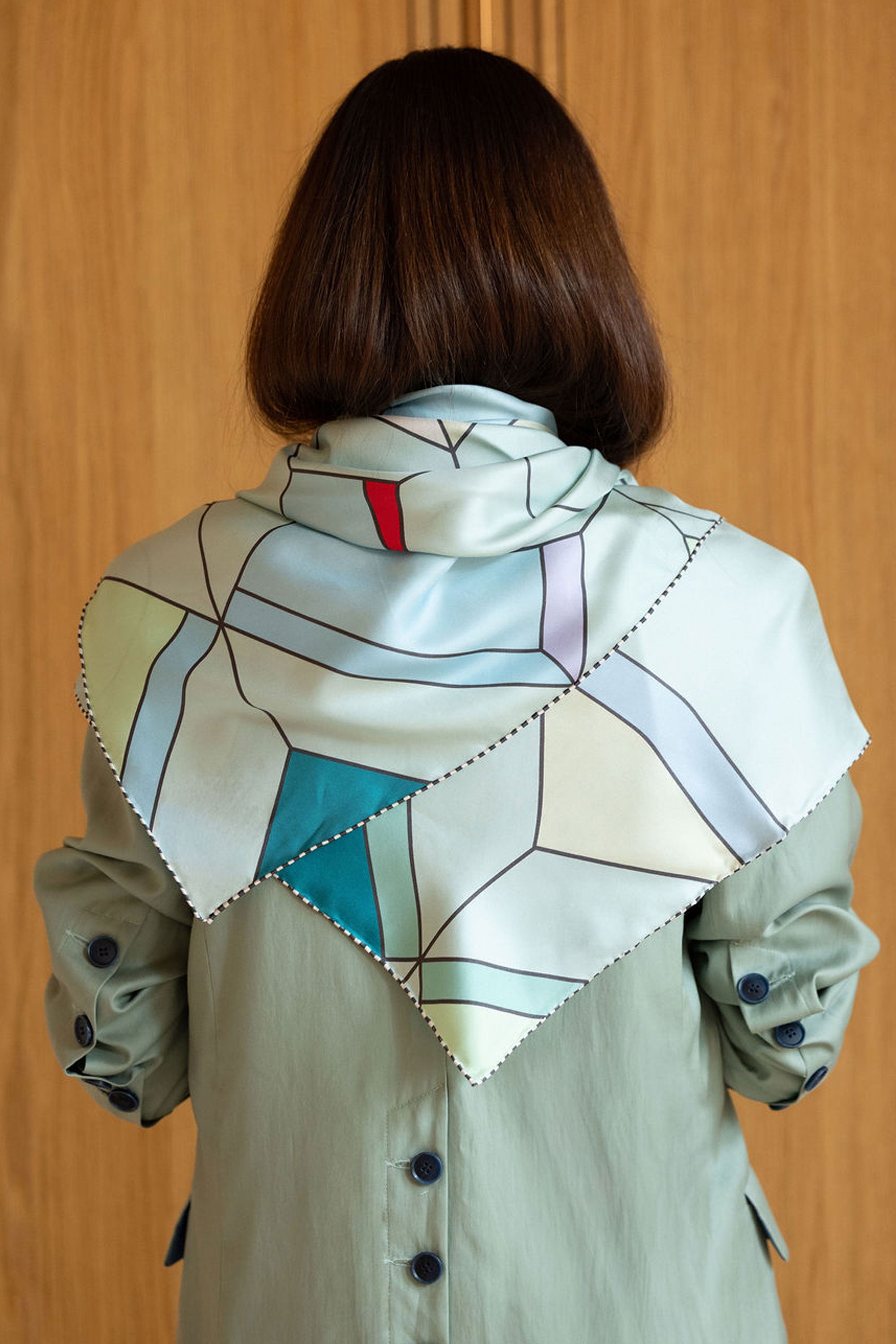 Luxury double faced Twill silk scarf on mint blazer in Art Deco pattern by MÀNA